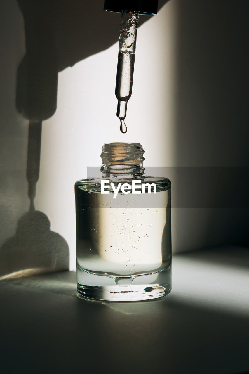 lighting, indoors, food and drink, drink, lamp, light, container, no people, refreshment, pouring, household equipment, table, light fixture, glass, still life