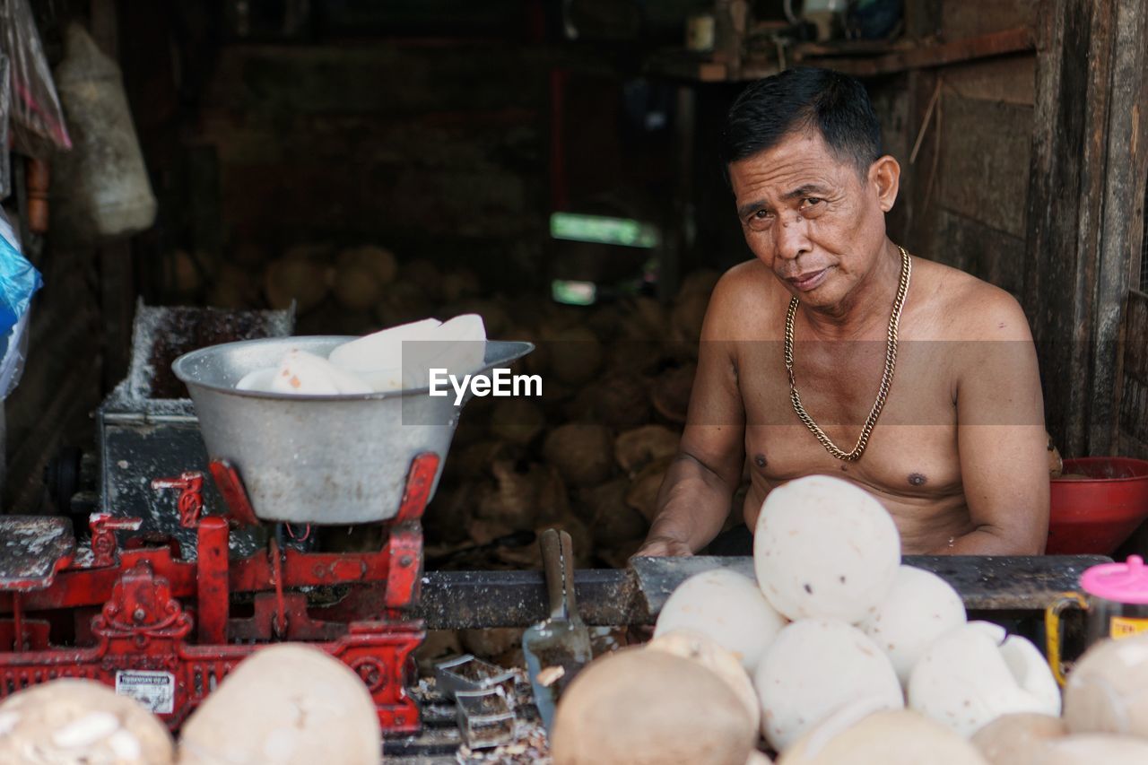 PORTRAIT OF WOMAN PREPARING FOOD