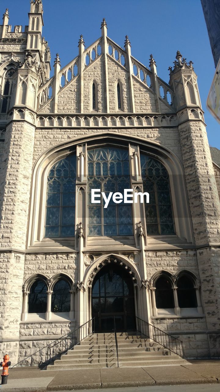 Low angle view of old church on sunny day