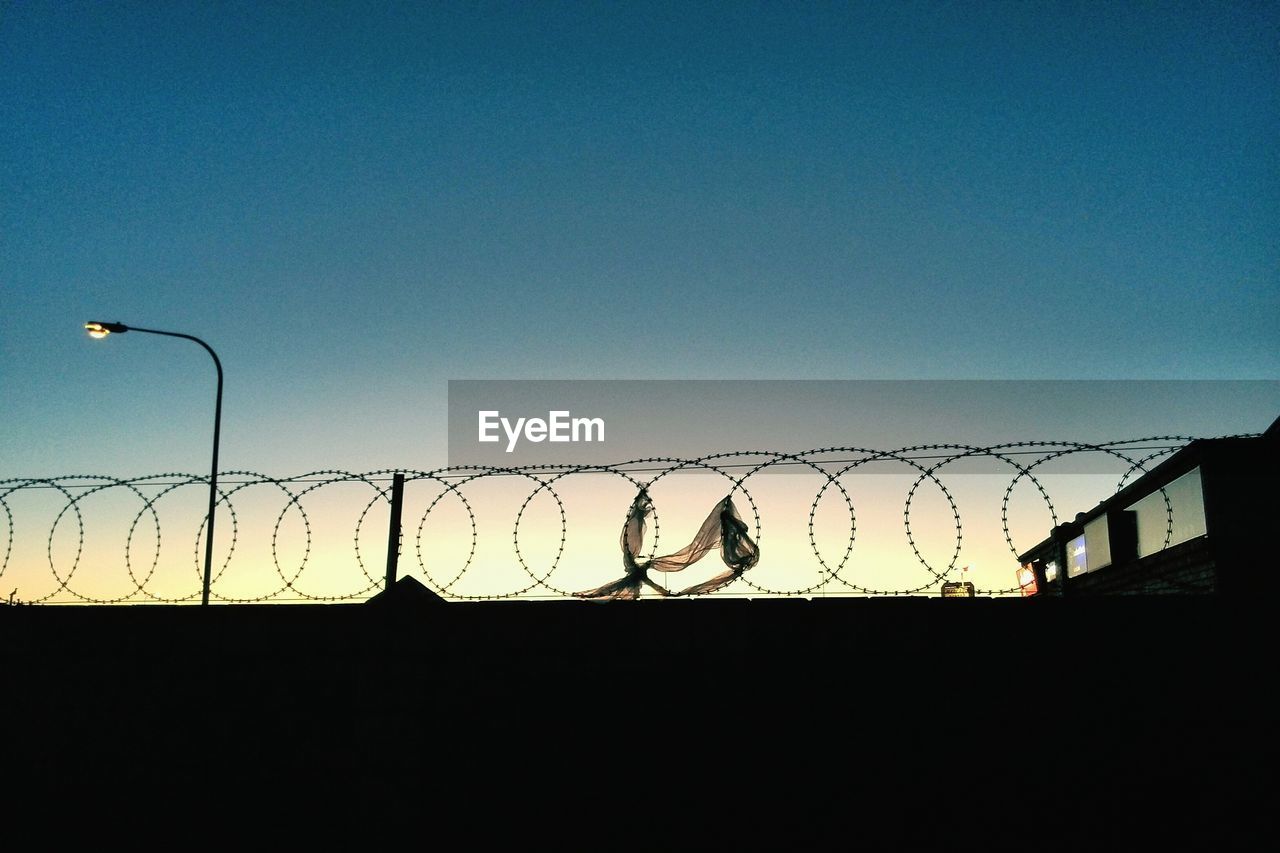 Barbed wire against sky