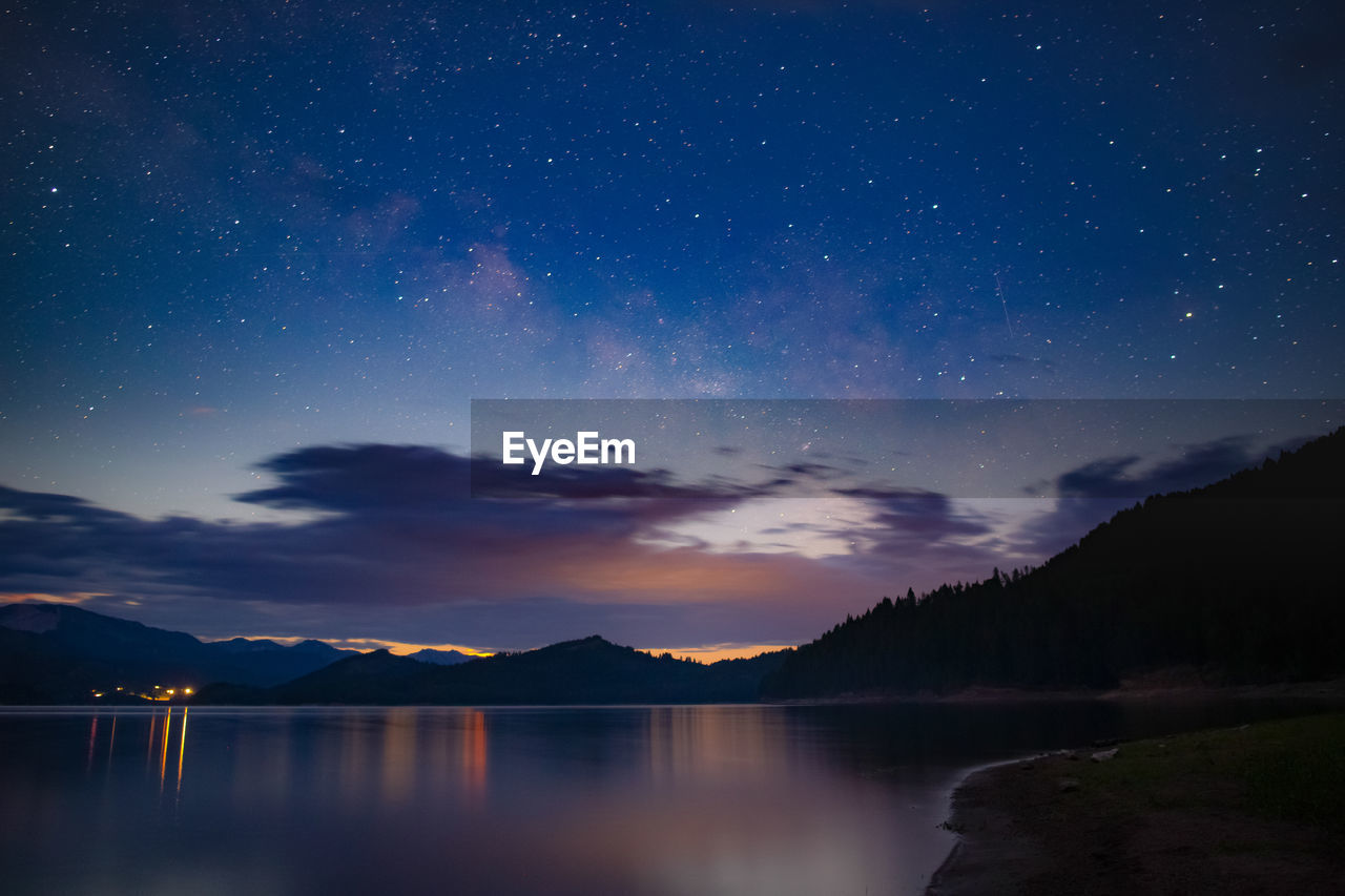 Waiting for the clouds to clear and the moon to rise over a mountain lake.