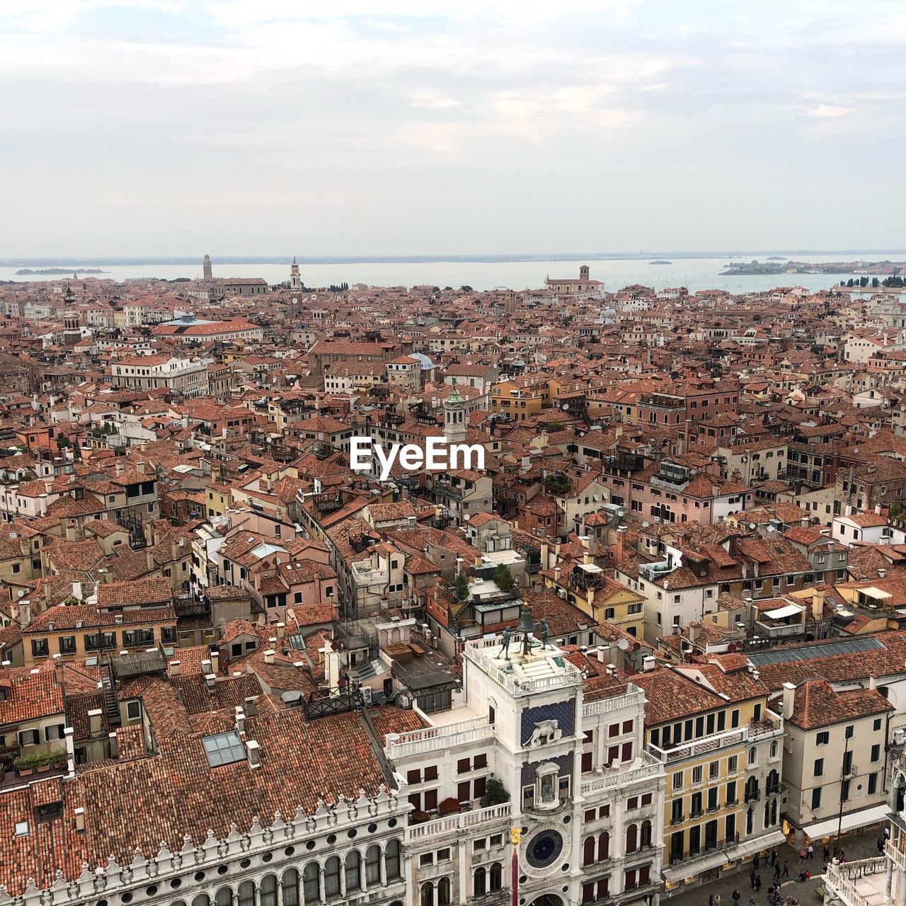 High angle view of townscape by sea against sky