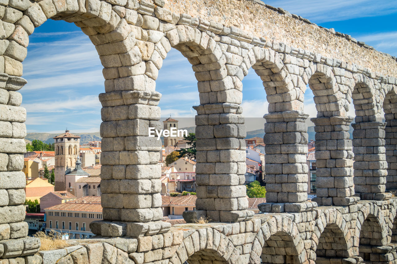 Aqueduct of segovia against sky in city