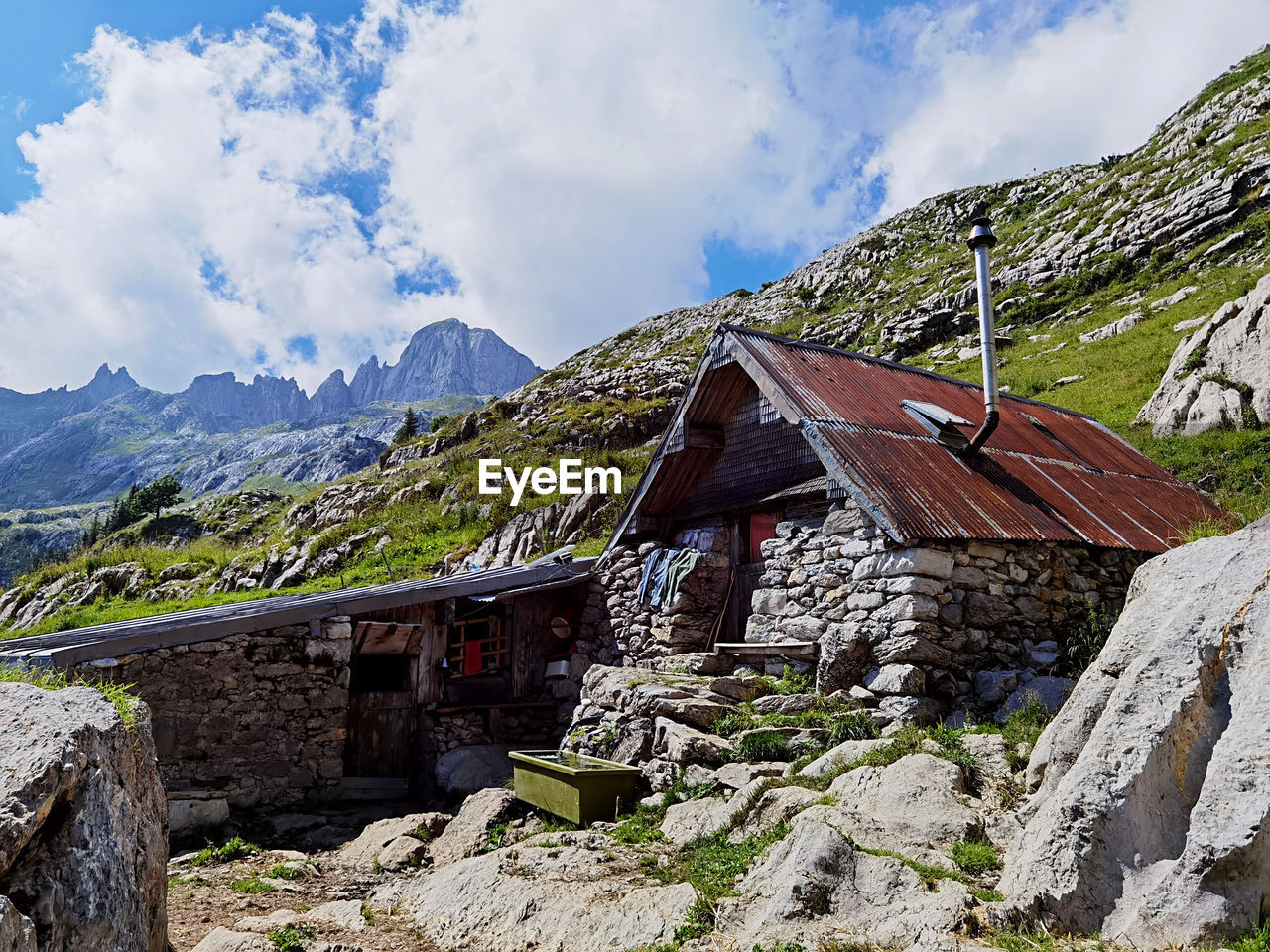 Panoramic view of houses and mountains against sky