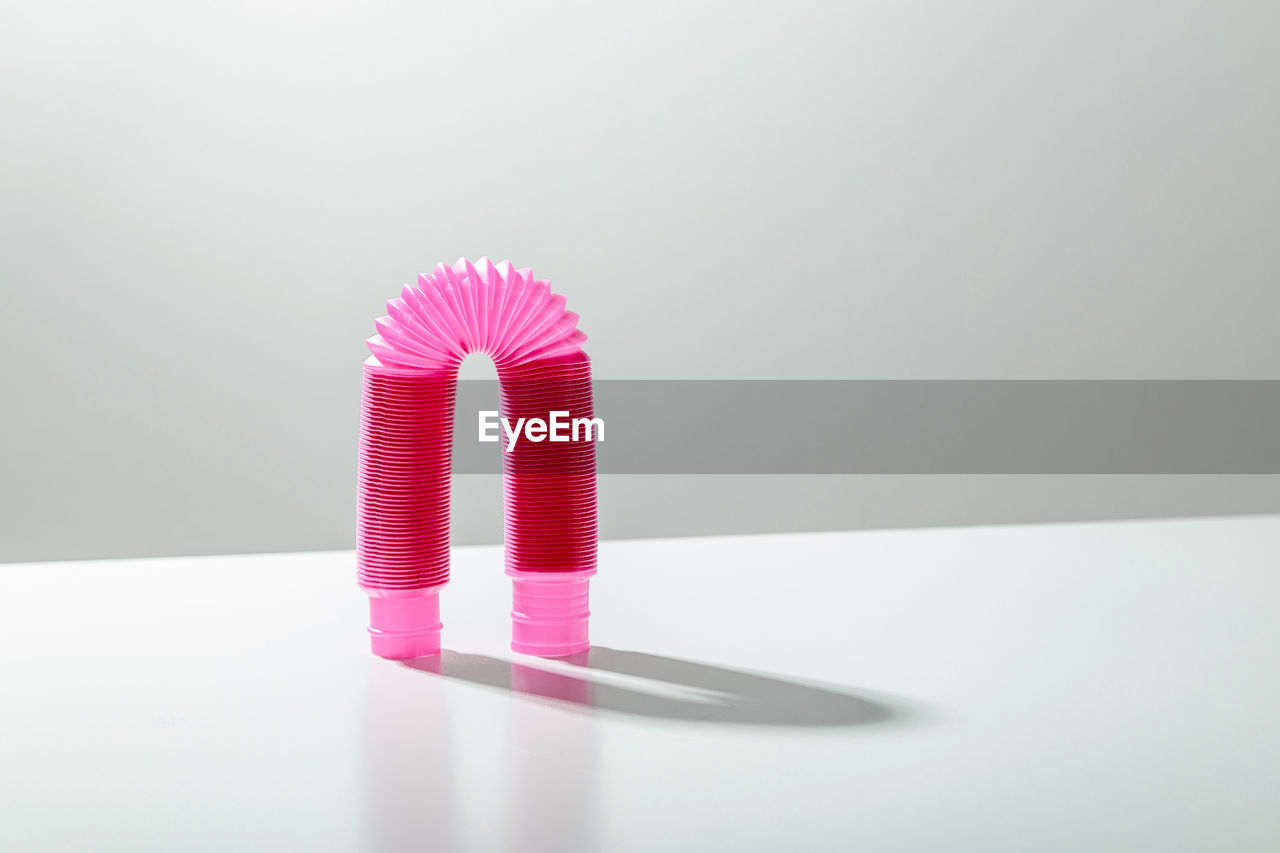 HIGH ANGLE VIEW OF PINK FLOWERS ON TABLE