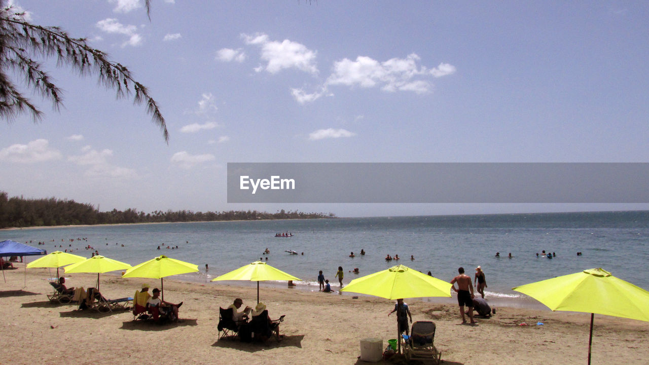 Scenic view of beach against sky on sunny day