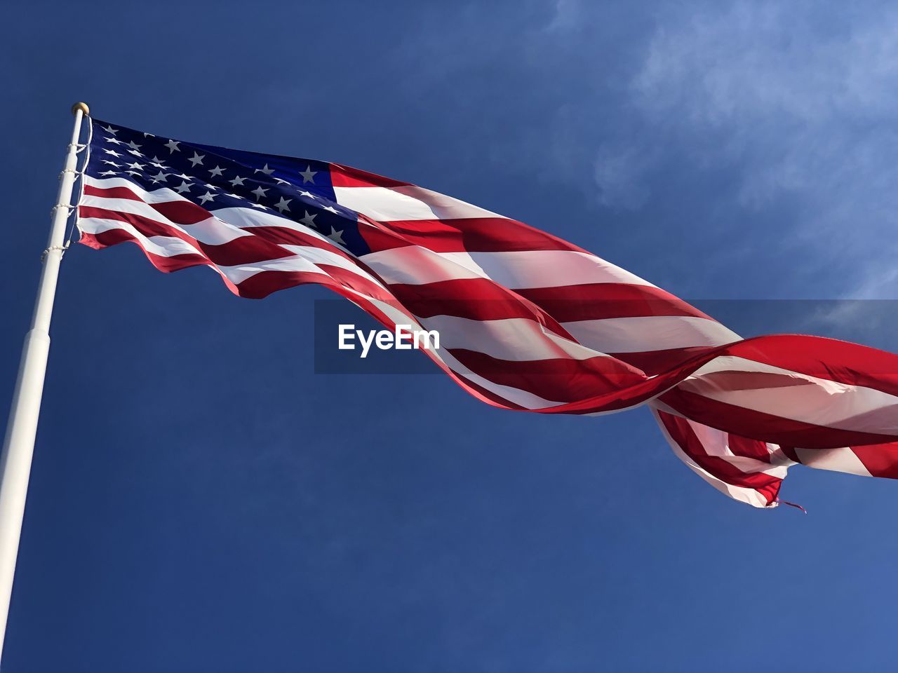 Low angle view of american flag against sky