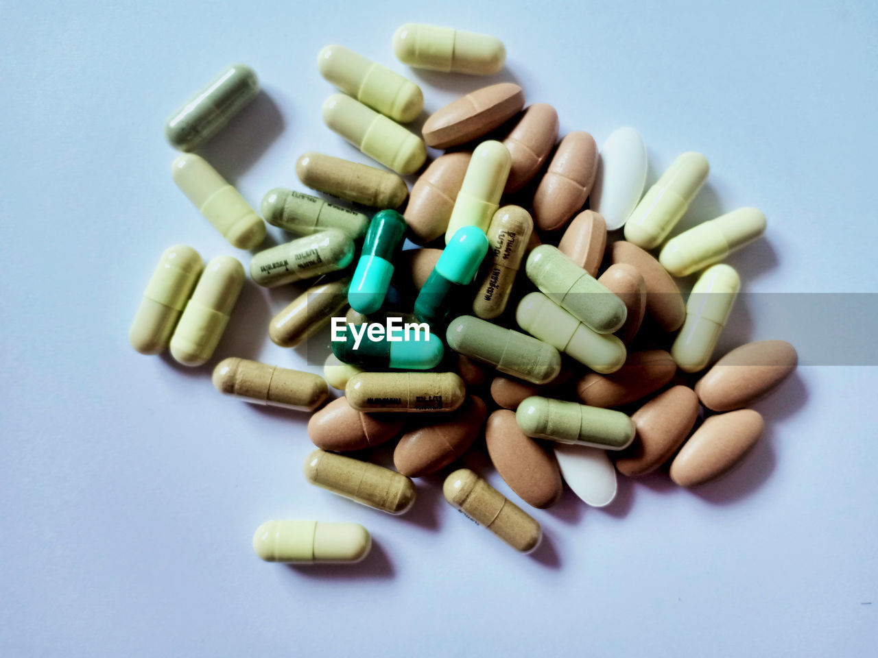 High angle view of pills on white background