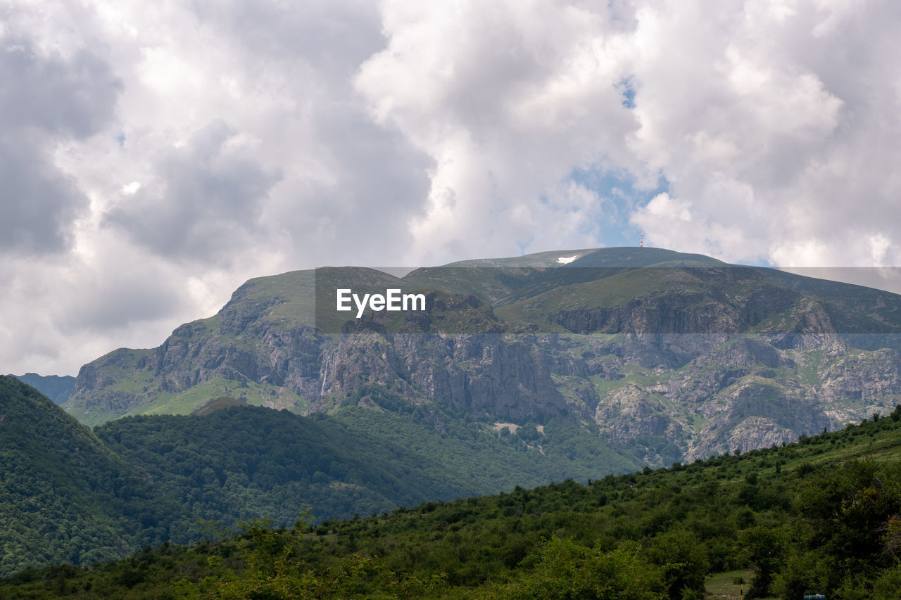 VIEW OF MOUNTAIN RANGE AGAINST CLOUDY SKY