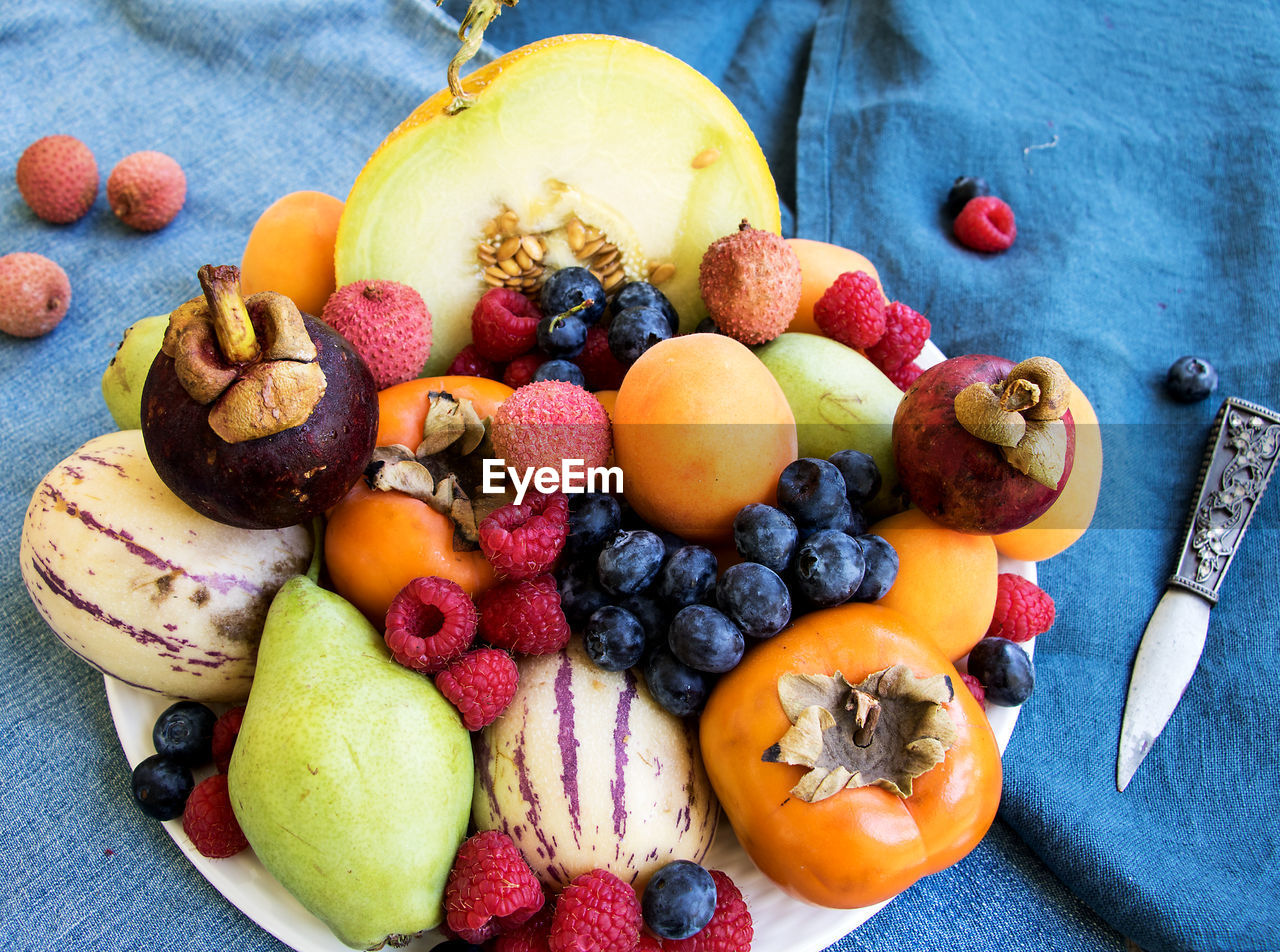 HIGH ANGLE VIEW OF FRUITS IN CONTAINER ON TABLE