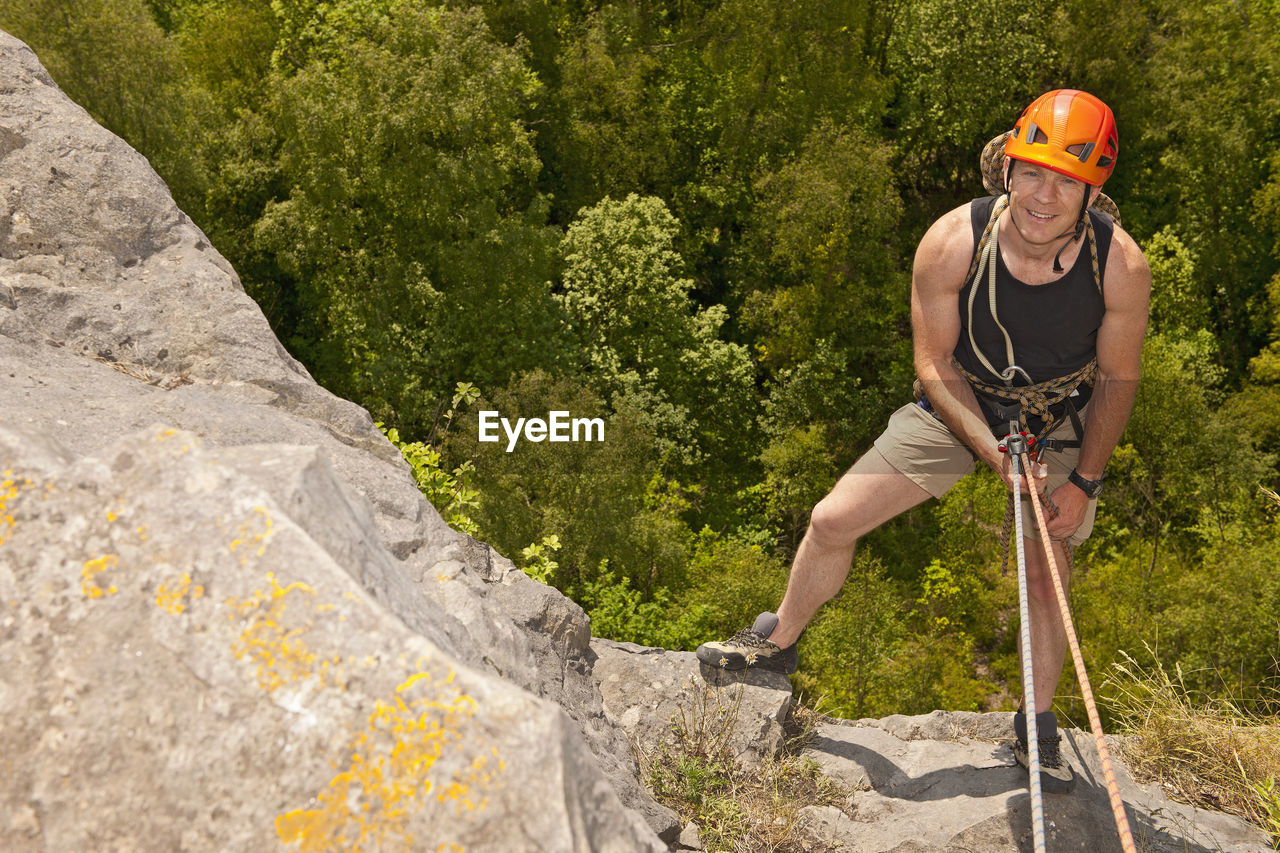 Man rappelling of cliff in south wales