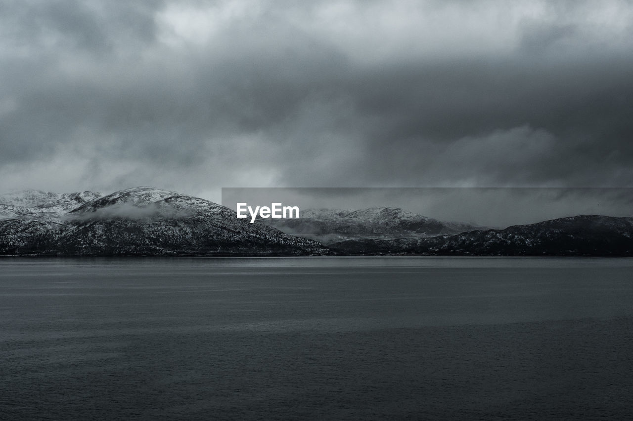 Scenic view of fjords against sky during winter