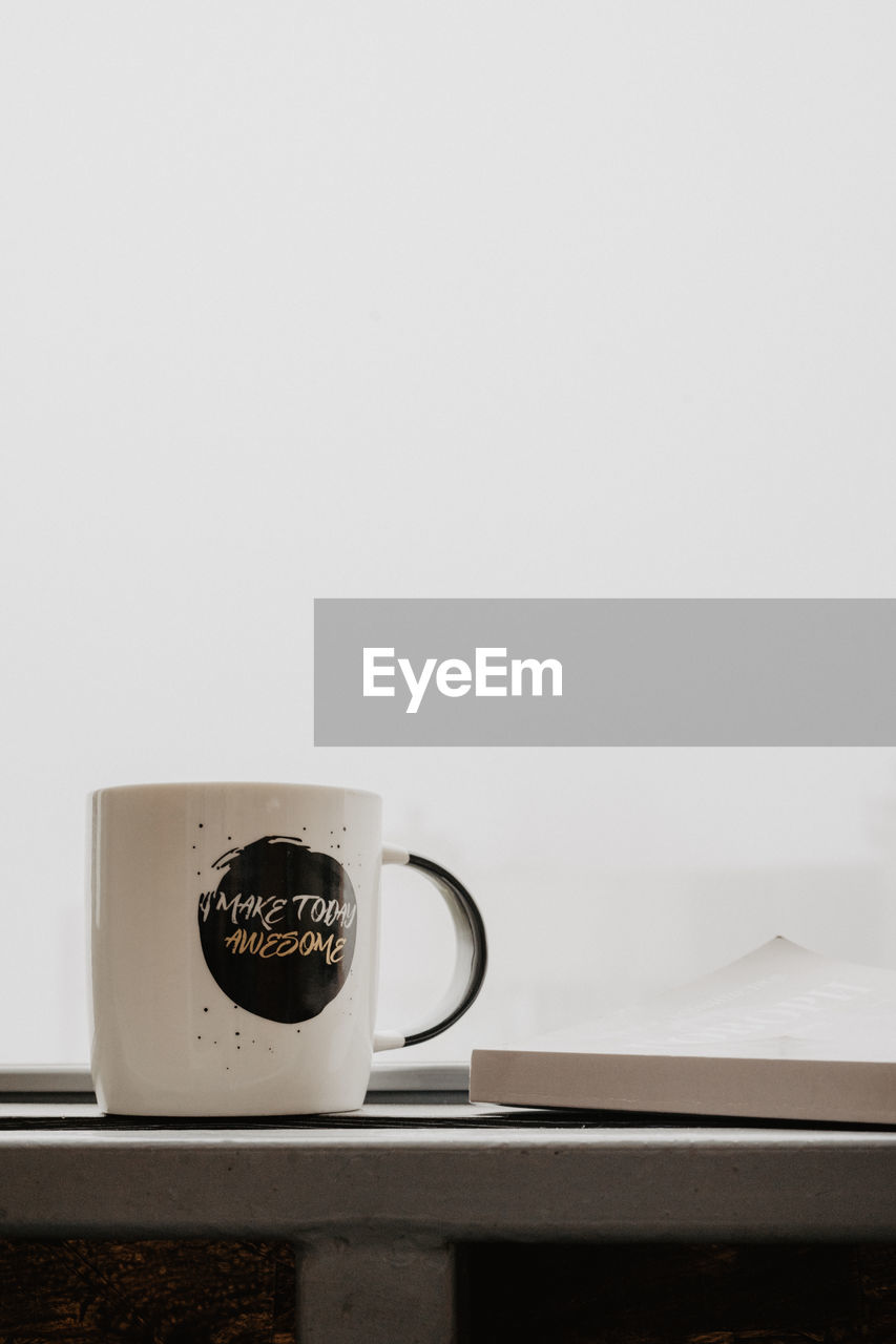 CLOSE-UP OF COFFEE CUP ON TABLE