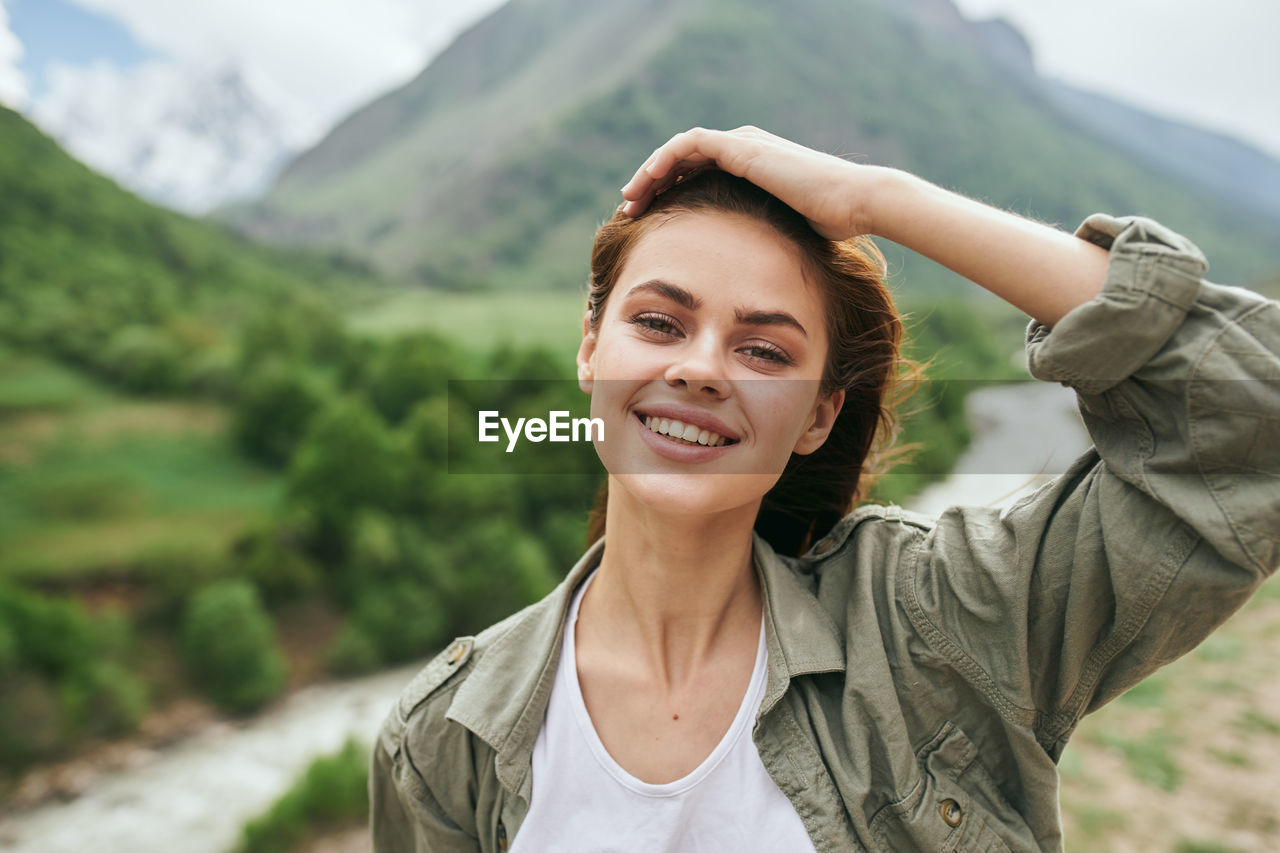 portrait of young woman looking at mountains