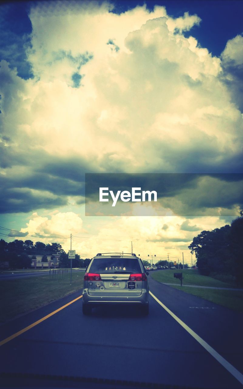 VIEW OF ROAD AGAINST CLOUDY SKY