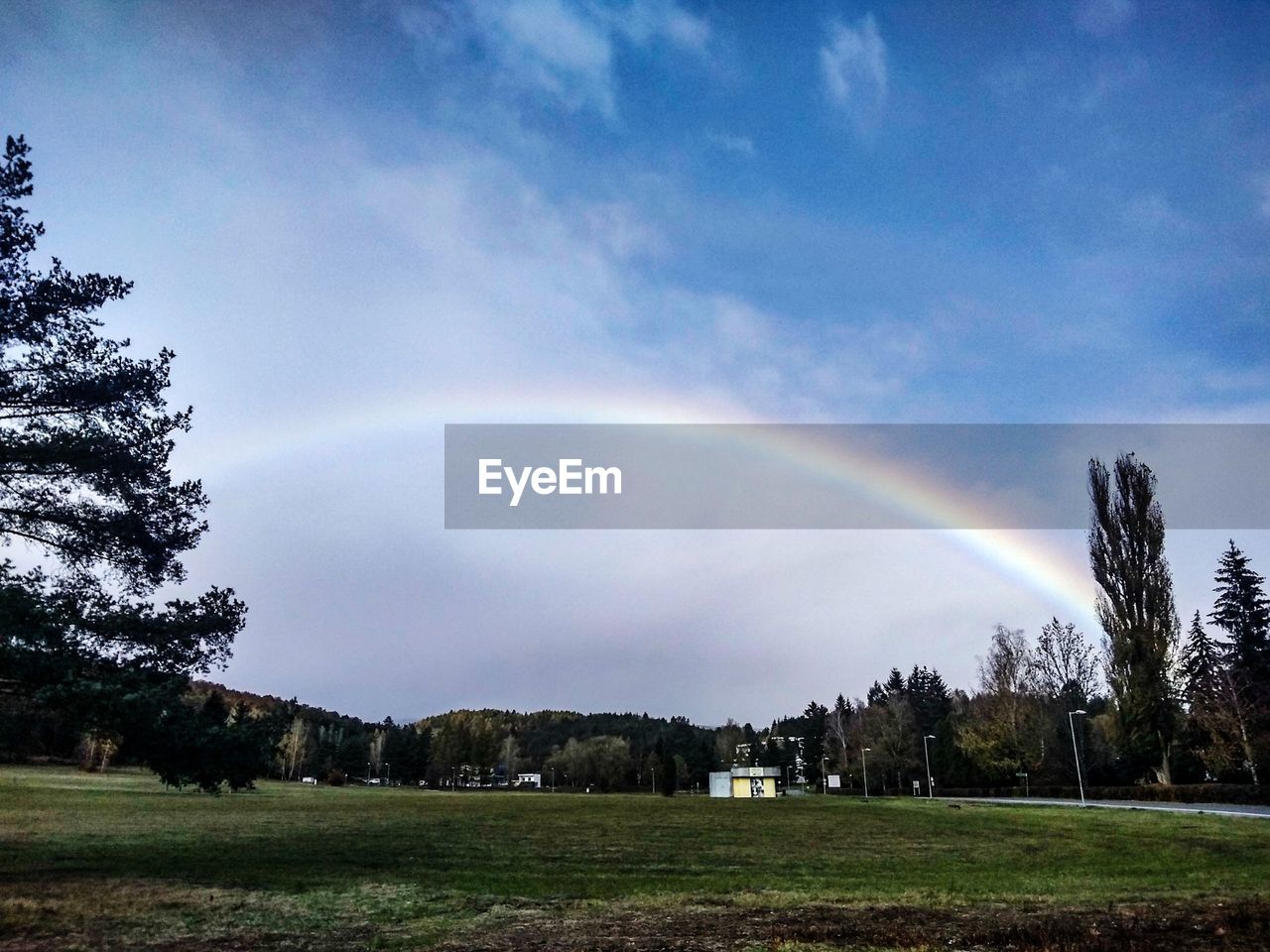 SCENIC VIEW OF RAINBOW OVER FIELD