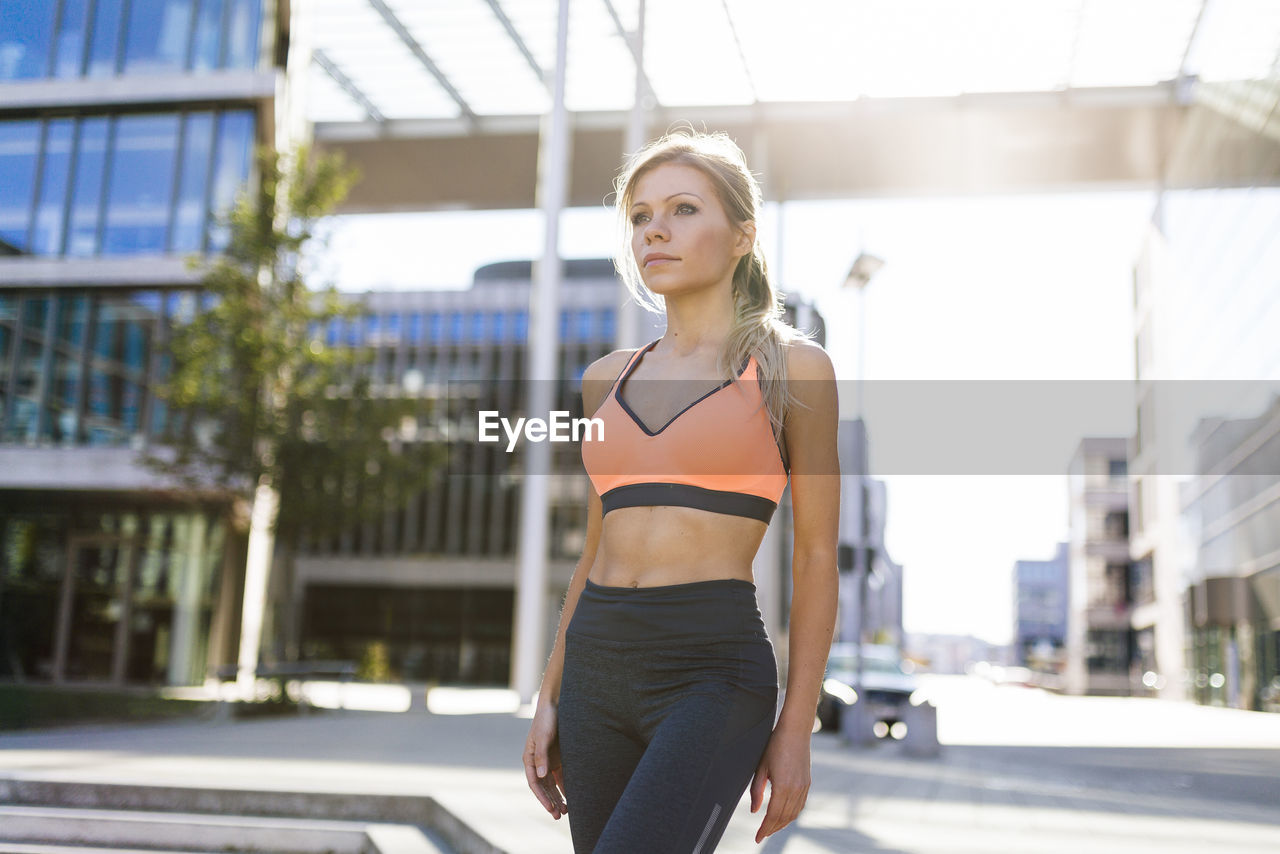 Woman in sports clothing standing in city