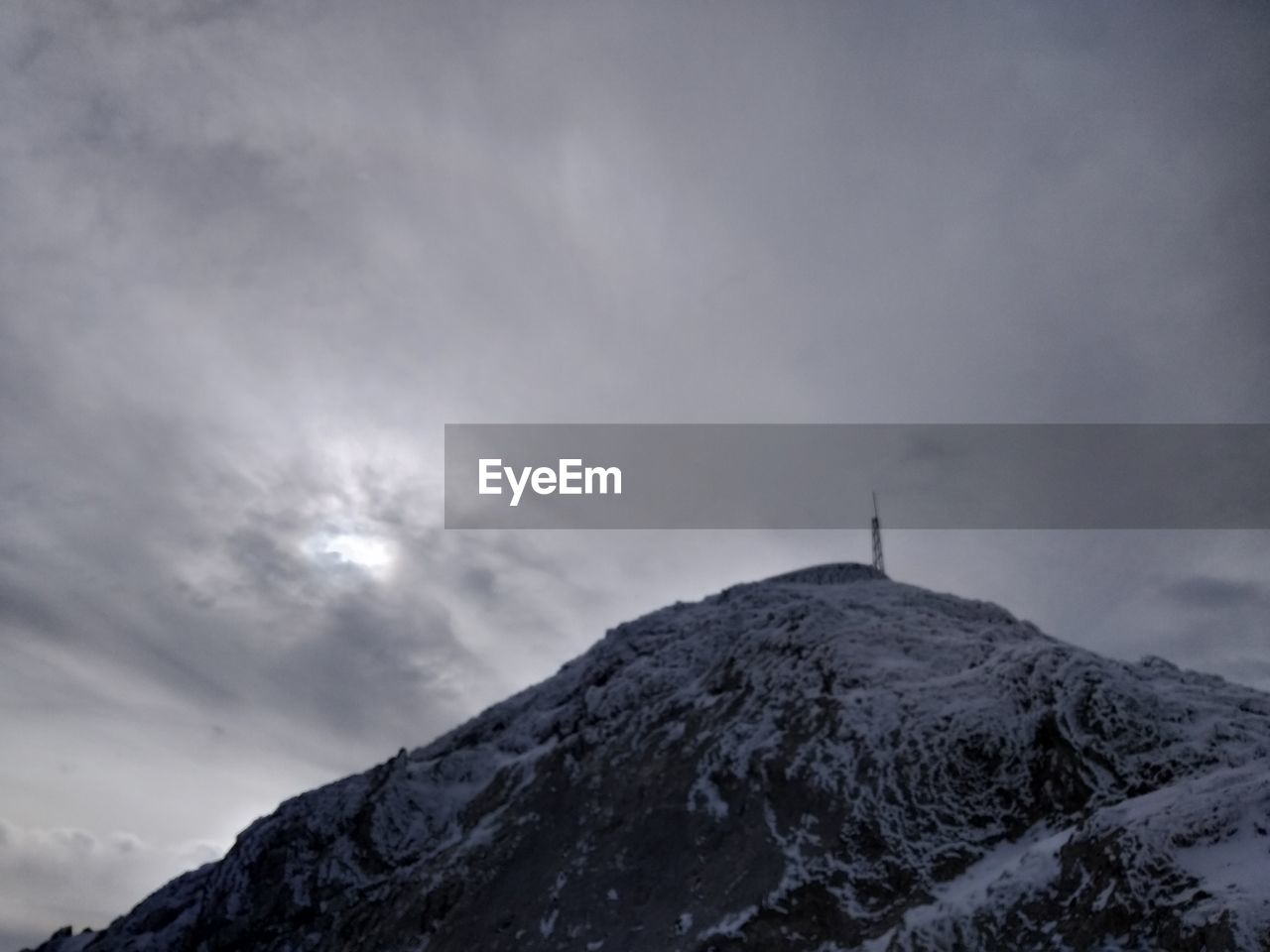 Low angle view of snowcapped mountain against sky