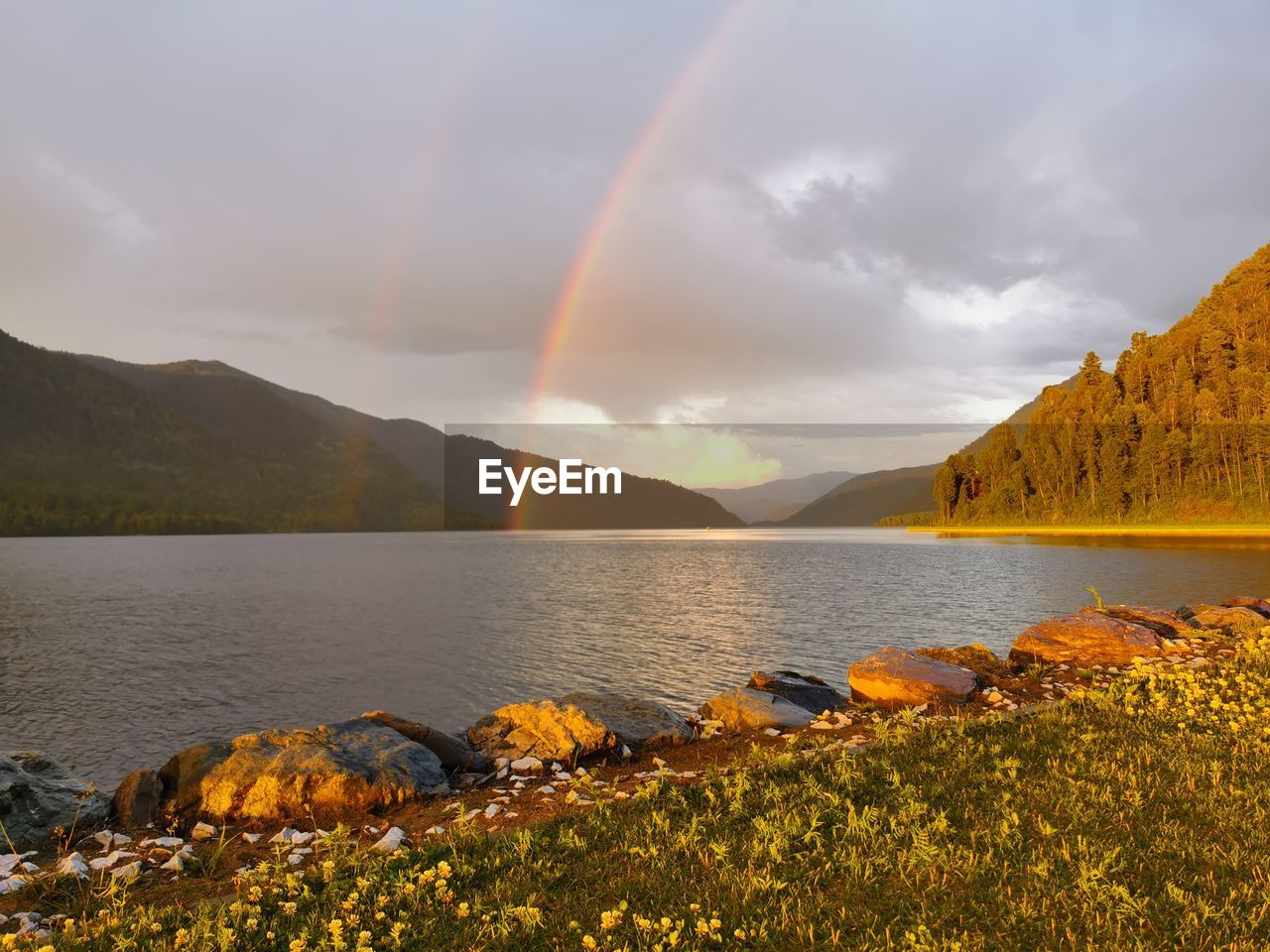 RAINBOW OVER LAKE AGAINST SKY