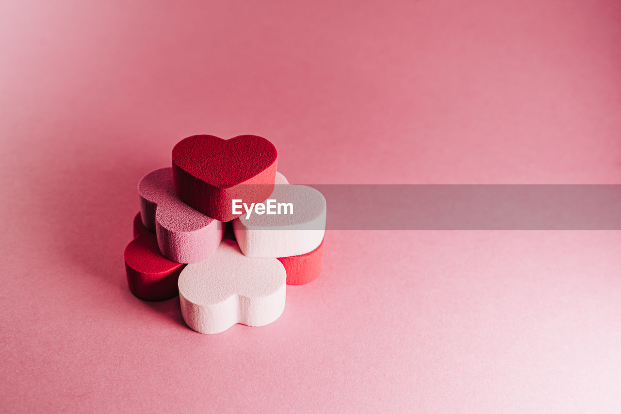 CLOSE-UP OF HEART SHAPE MADE ON PINK PAPER