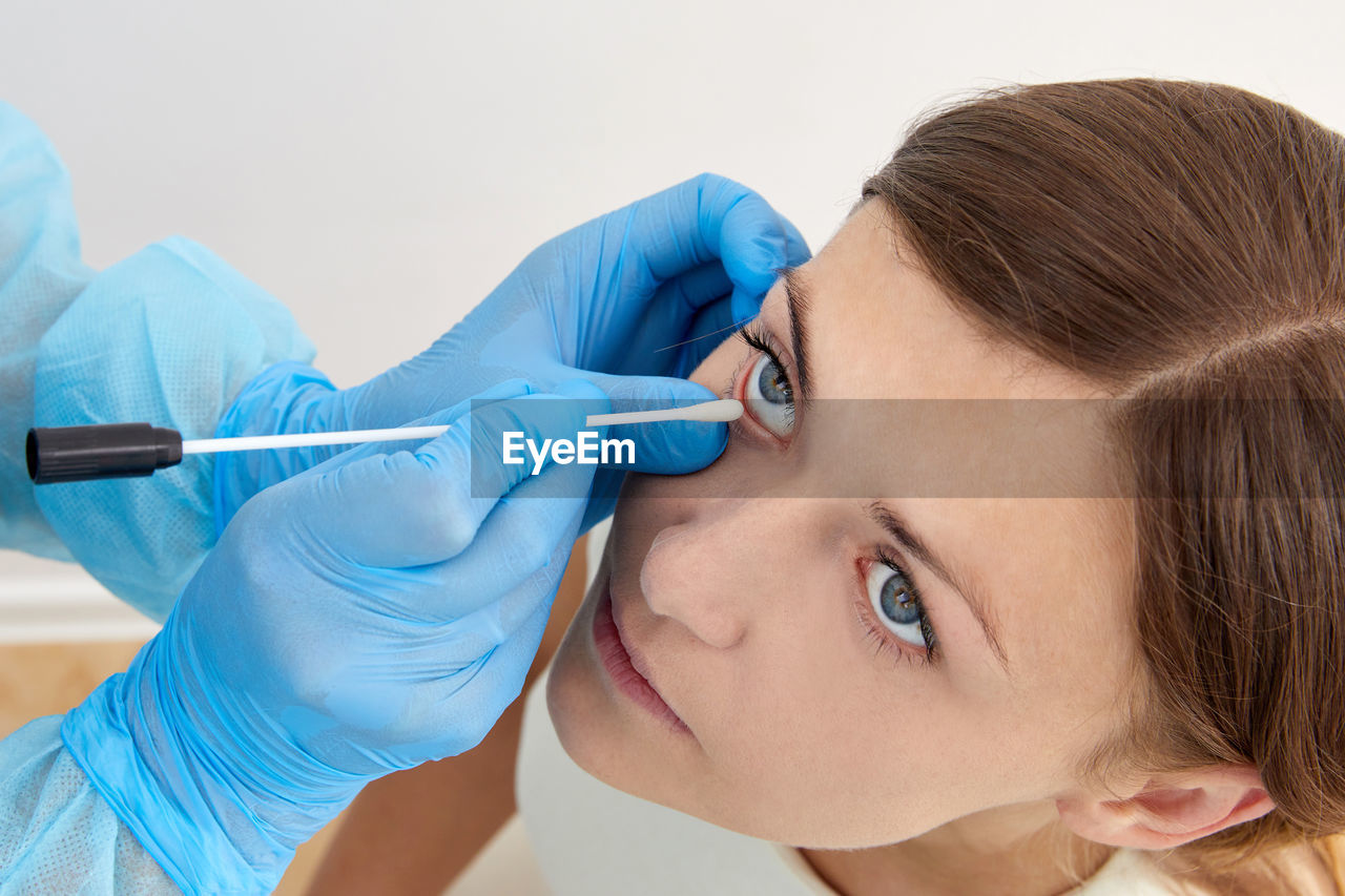 Doctor examining eye of patient