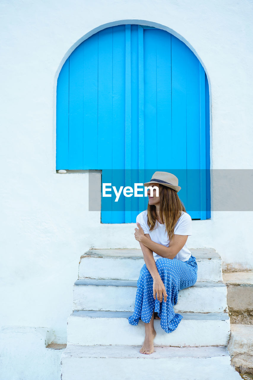 Isolated cheerful woman on holidays in europe. woman on the stairs on spanish travel destination.