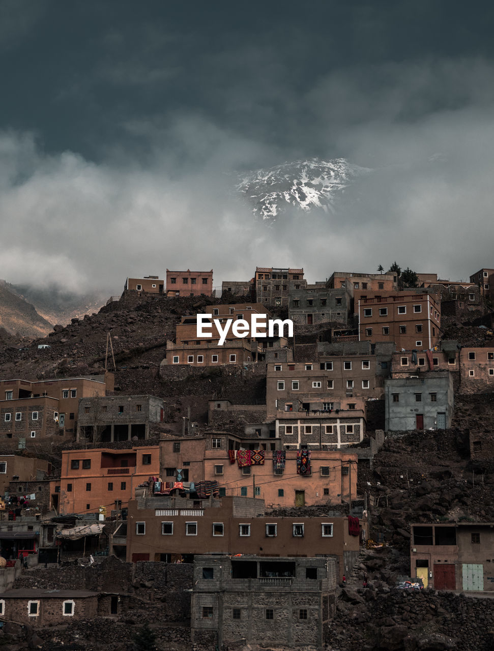 Low angle view of buildings in town against sky