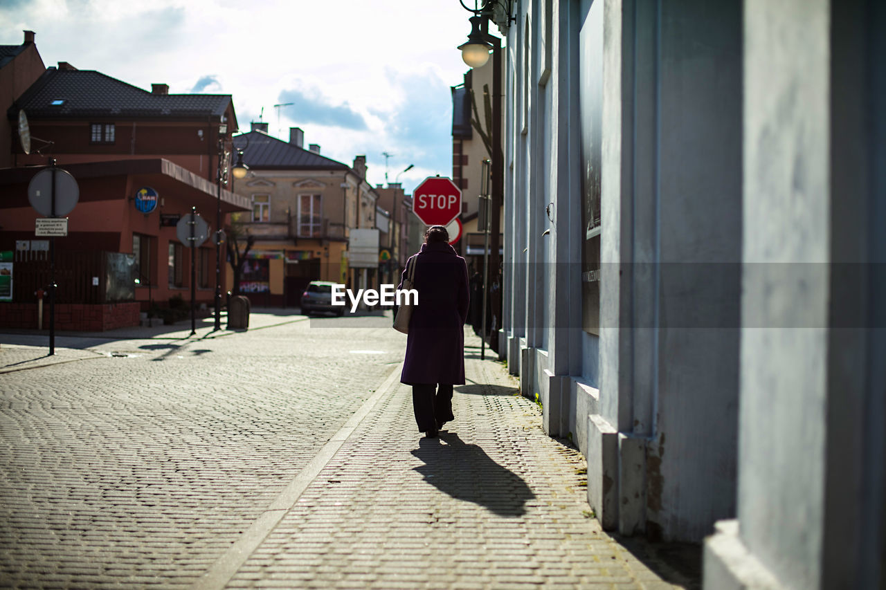 Rear view of woman walking on street