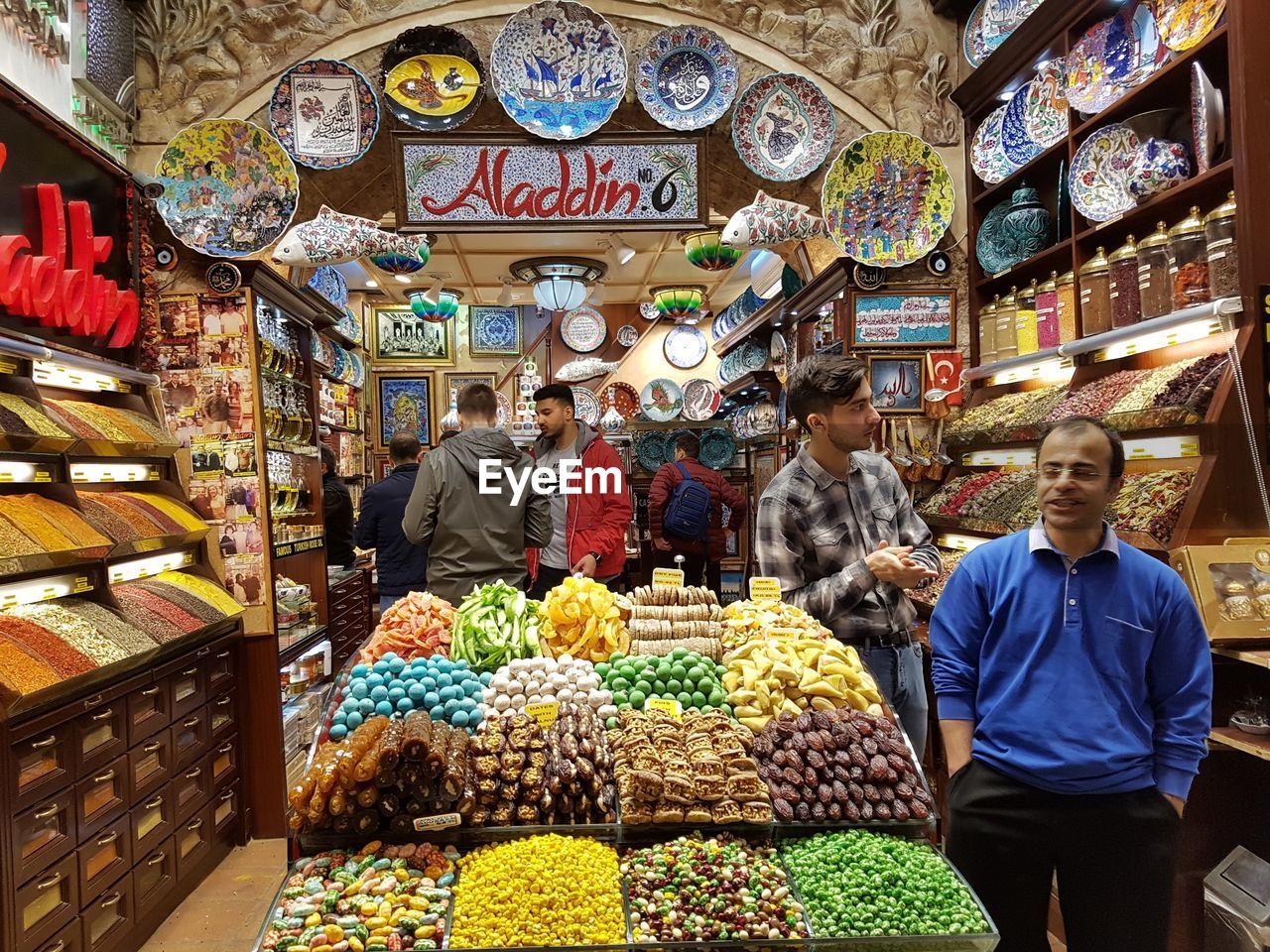 PEOPLE STANDING AT MARKET STALL IN STORE