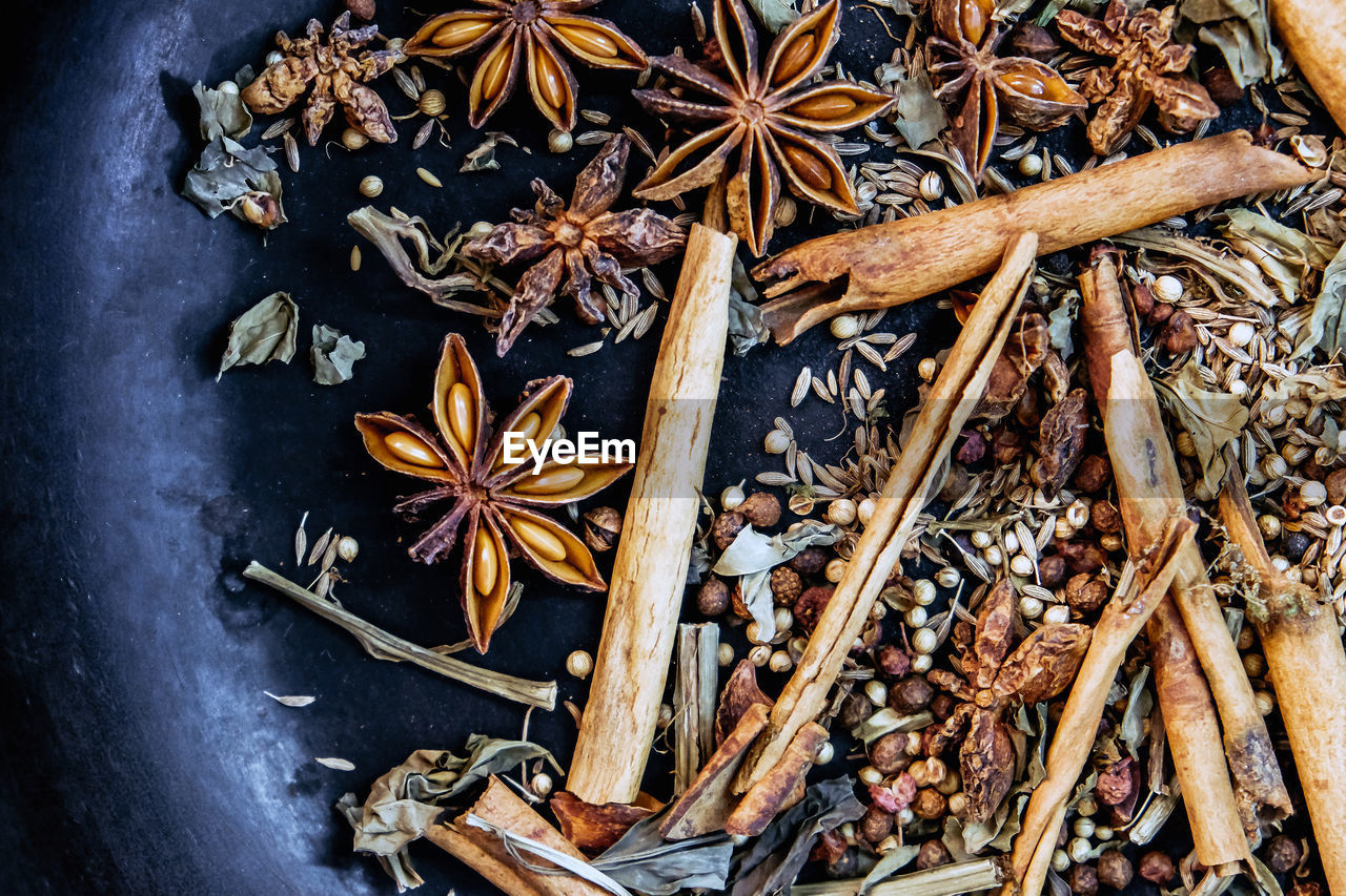 spice, star anise, cinnamon, leaf, wood, food and drink, high angle view, food, ingredient, no people, large group of objects, branch, still life, tree, abundance, clove, indoors, directly above, twig, nature, variation, healthy eating, iron, plant, anise, freshness, wellbeing, herb