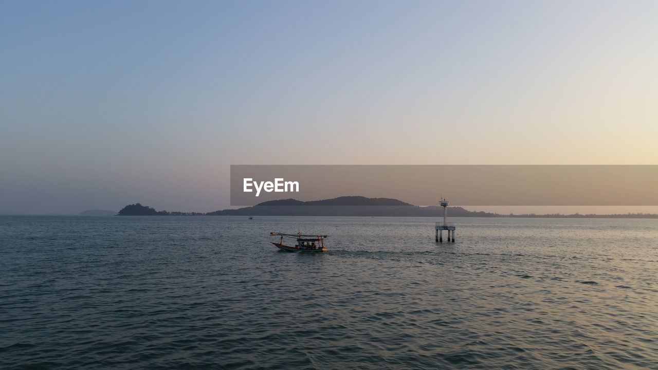 Scenic view of sea against clear sky during sunset