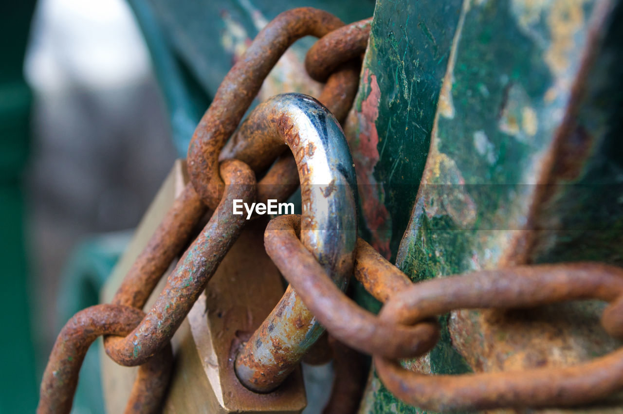 Close-up of rusty chain and padlock on gate