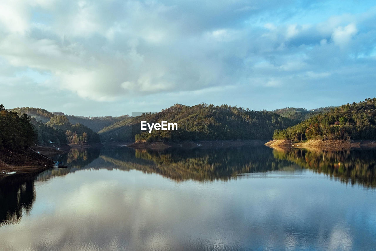 Scenic view of lake and mountains against sky