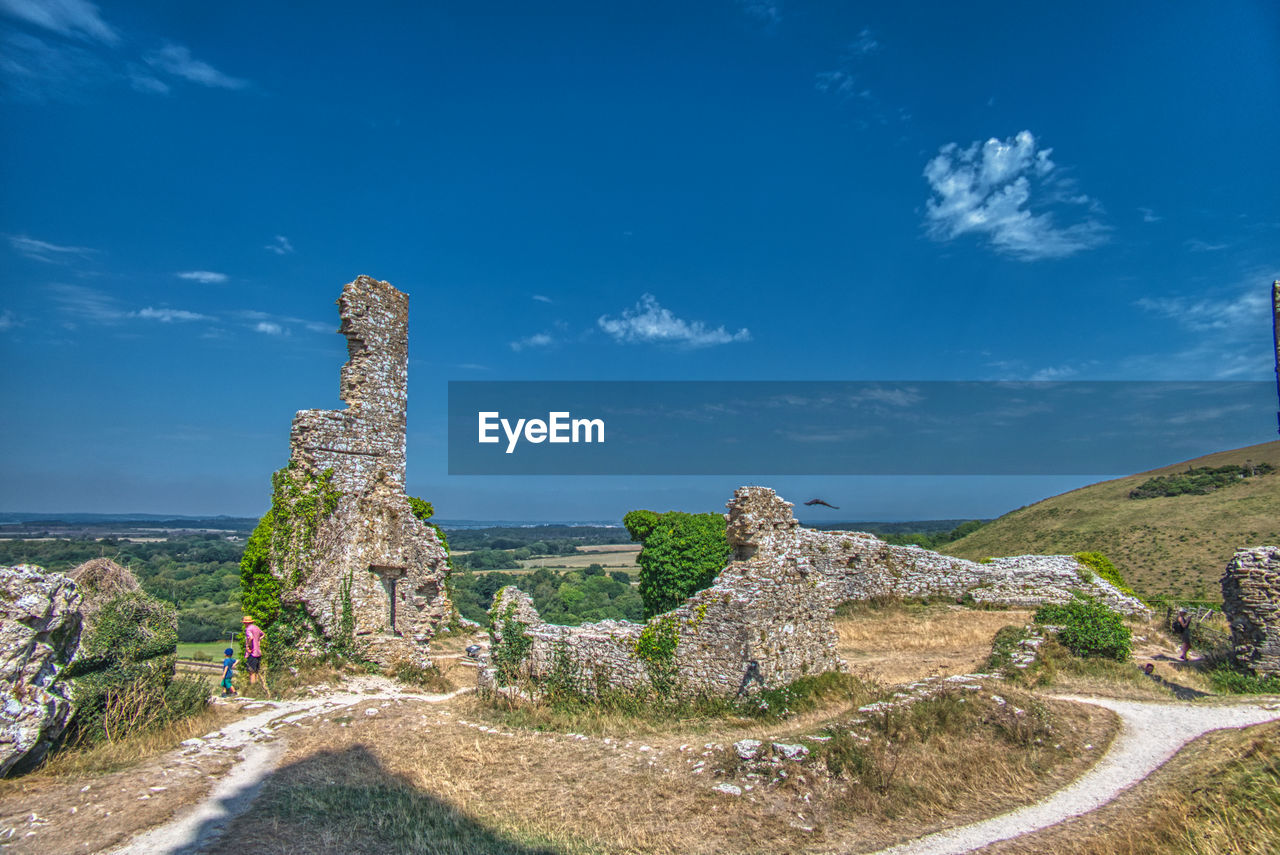 Panoramic view of old ruins against blue sky