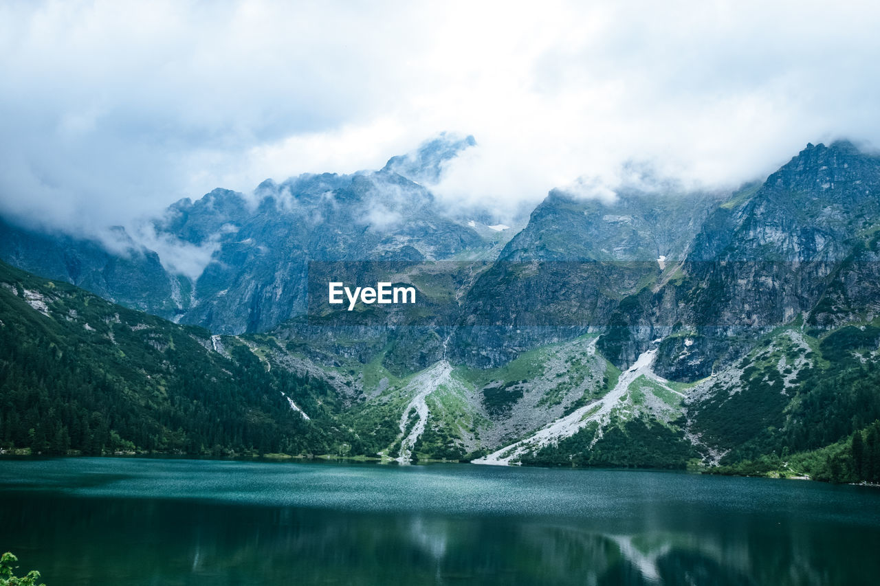 Scenic view of lake and mountains against sky