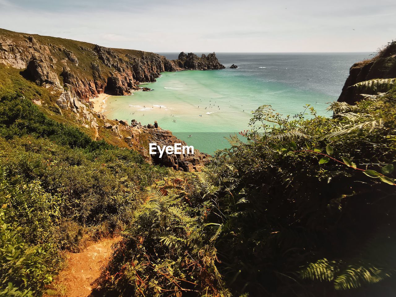 HIGH ANGLE VIEW OF ROCKS ON BEACH AGAINST SKY