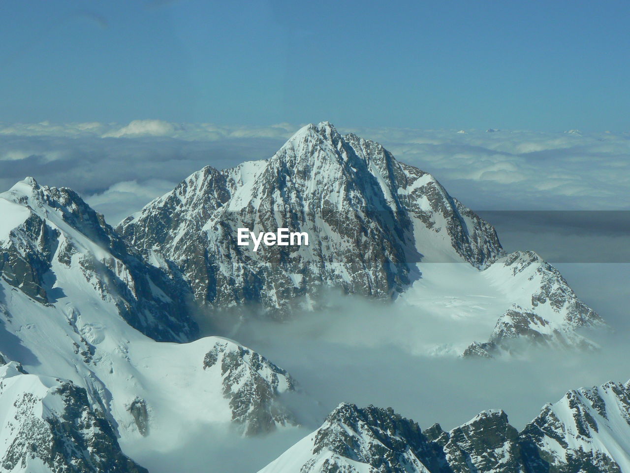 Scenic view of snowcapped mountains against sky - flying over the southern alps, new zealand 