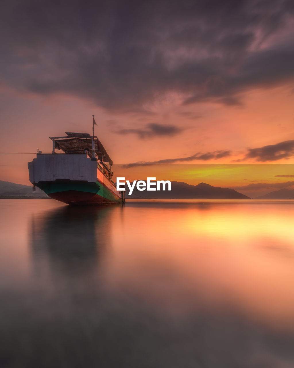 The color of the sunset is so beautiful that the boat is docked