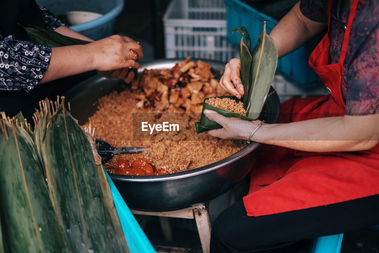 Man preparing food for sale at market stall