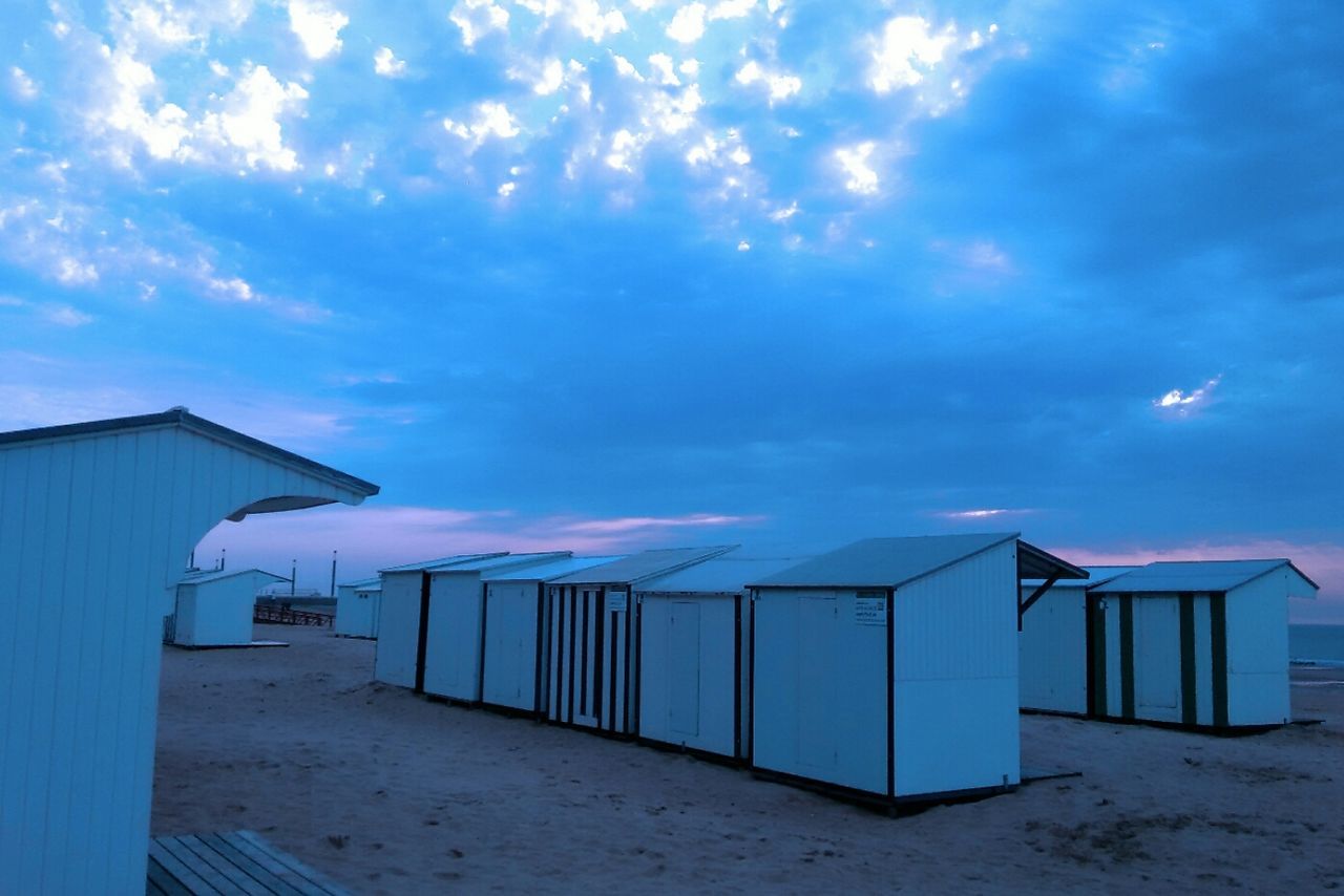 LIFEGUARD HUT ON BEACH AGAINST SKY