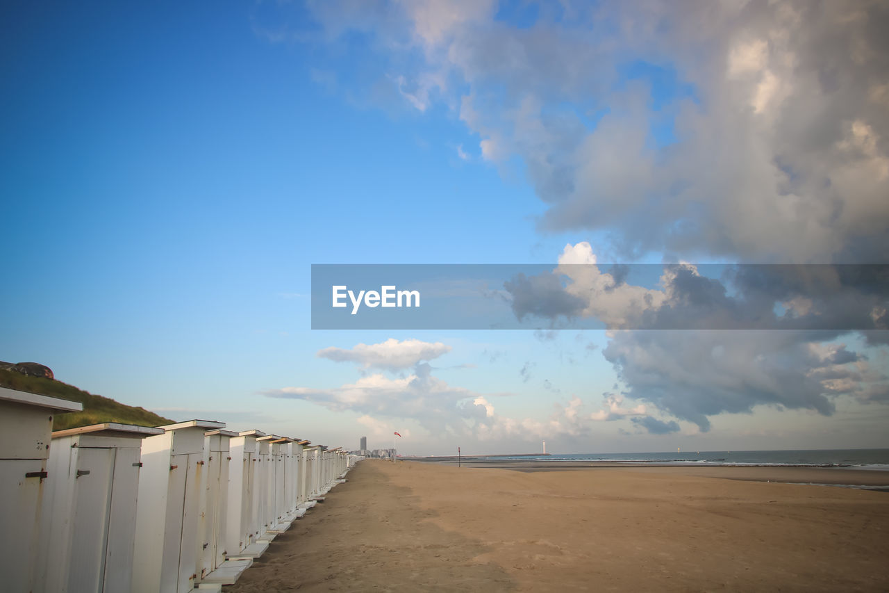 Scenic view of beach against blue sky