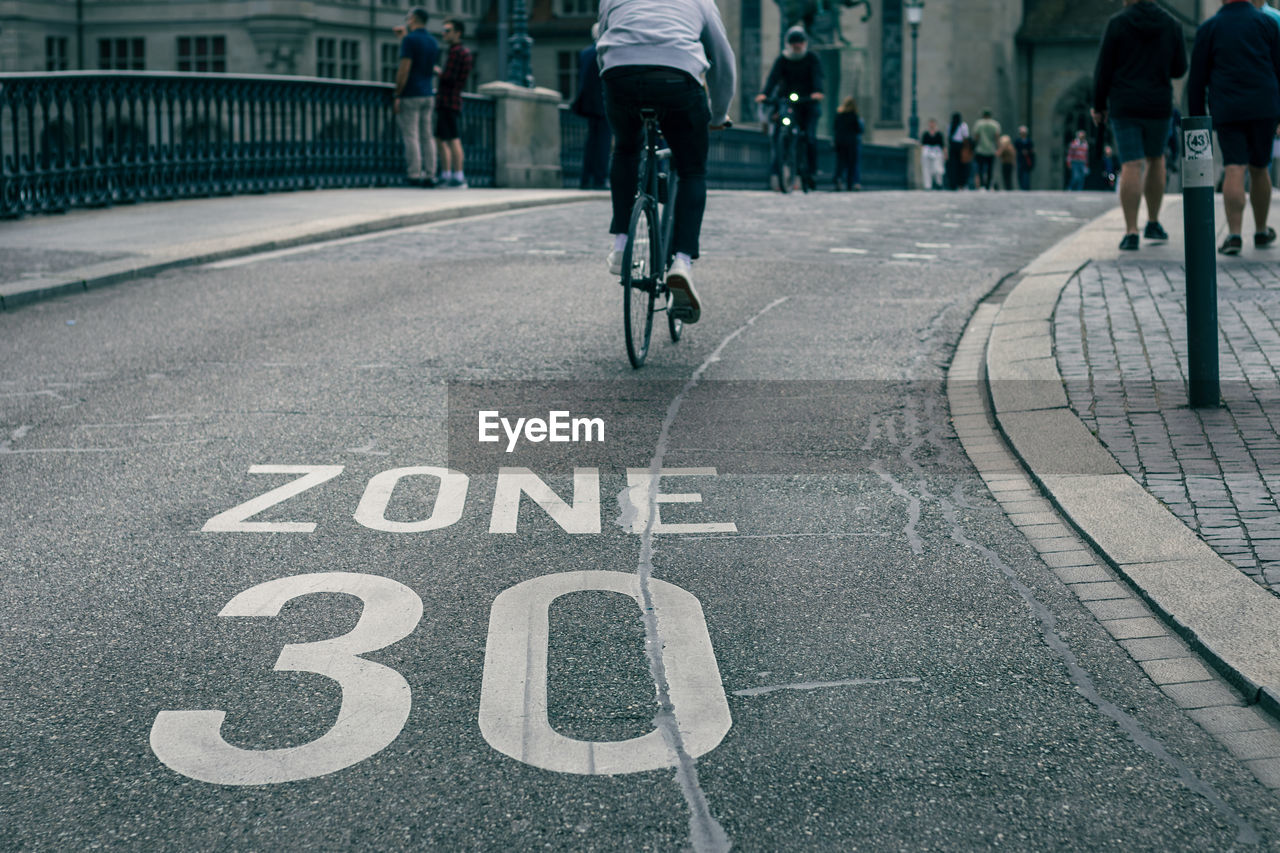 Speed limit sign on street, bicycle on road at area of zone 30 speed limit