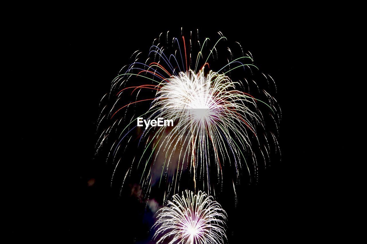 fireworks, illuminated, motion, firework display, celebration, night, event, arts culture and entertainment, exploding, glowing, long exposure, recreation, no people, firework - man made object, low angle view, sky, nature, multi colored, blurred motion, outdoors
