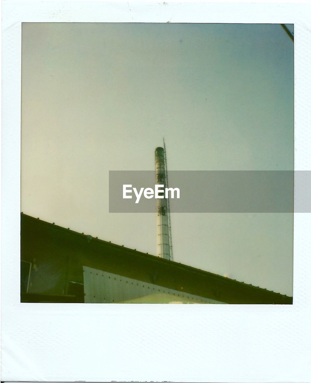 Low angle view of smoke stack against sky