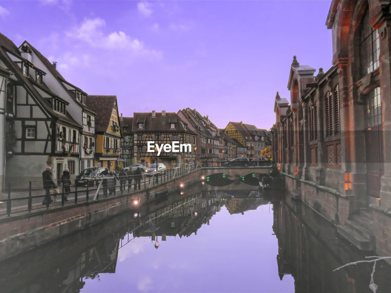 ARCH BRIDGE OVER CANAL AMIDST BUILDINGS AGAINST SKY