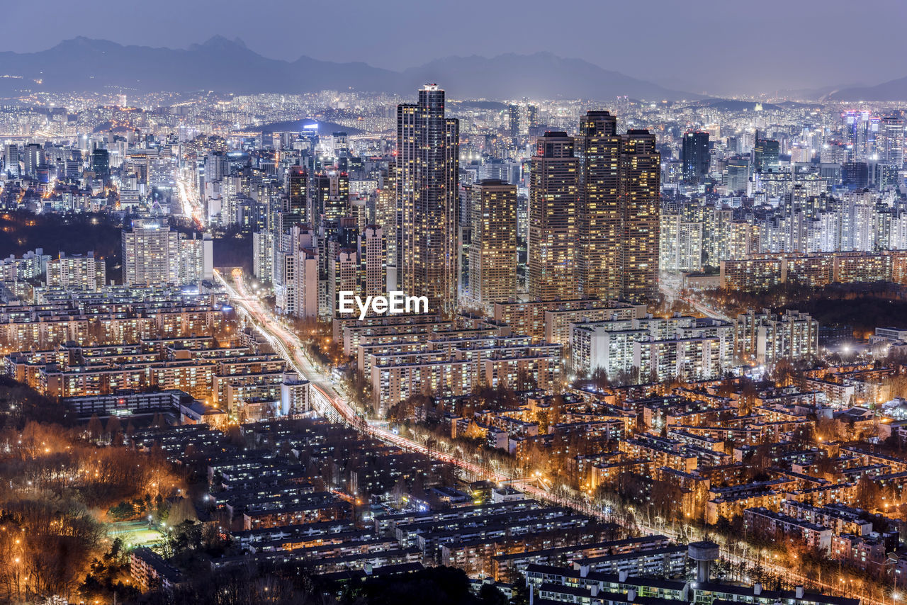 High angle view of illuminated city buildings at night