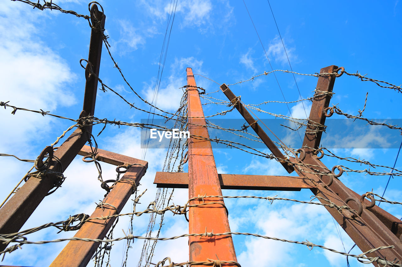 sky, electricity, cloud, mast, overhead power line, blue, nature, low angle view, no people, architecture, tower, electrical supply, transmission tower, outdoor structure, outdoors, day, industry, vehicle, transportation, cable, nautical vessel, ship