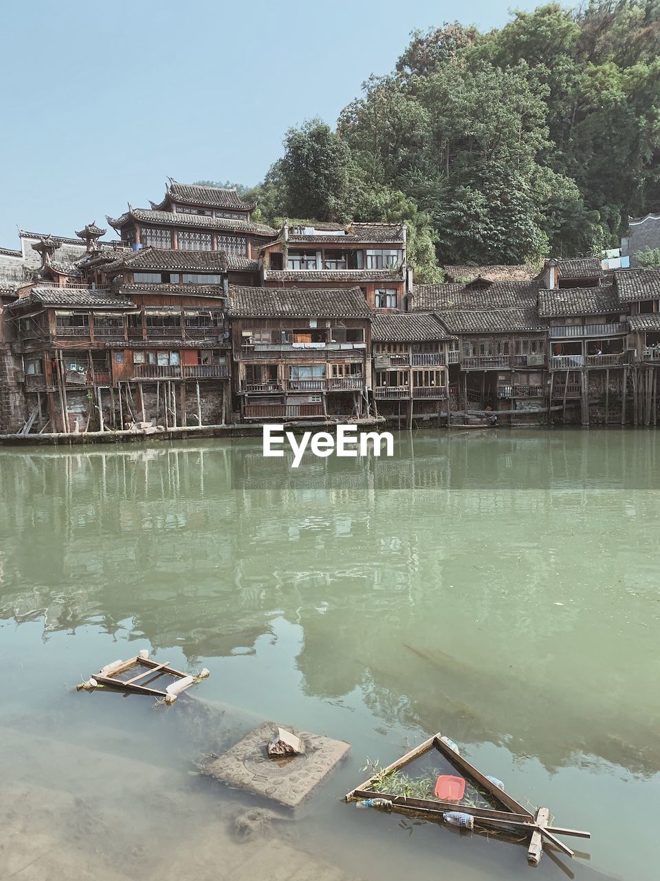 BUILT STRUCTURE BY LAKE AGAINST SKY