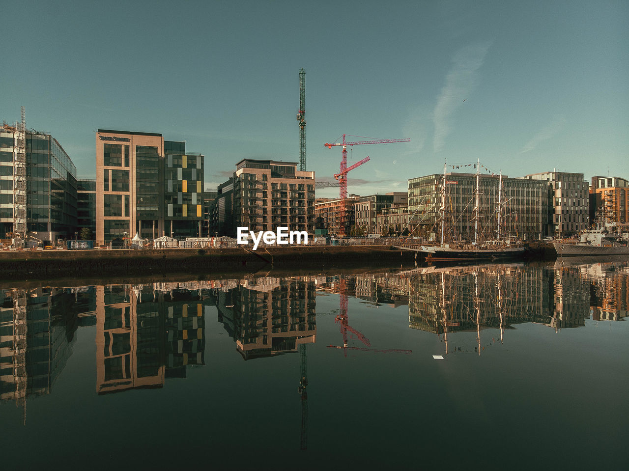 Reflection of buildings in lake against sky