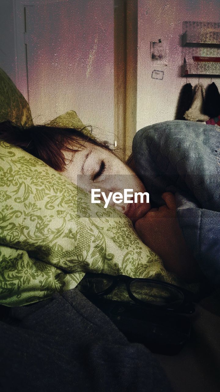 CLOSE-UP OF WOMAN SLEEPING IN BED